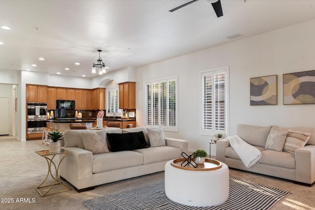 11193 N 121st Way, Scottsdale, AZ 85259 - living room featuring ceiling fan, recessed lighting, light colored carpet, and a chandelier