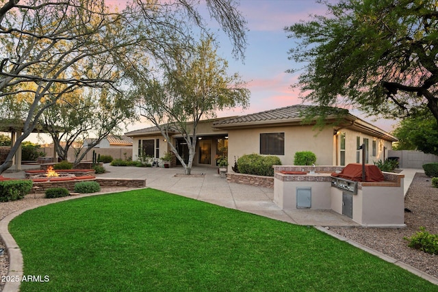 11193 N 121st Way, Scottsdale, AZ 85259 - rear view of property featuring area for grilling, a patio area, stucco siding, and a tile roof