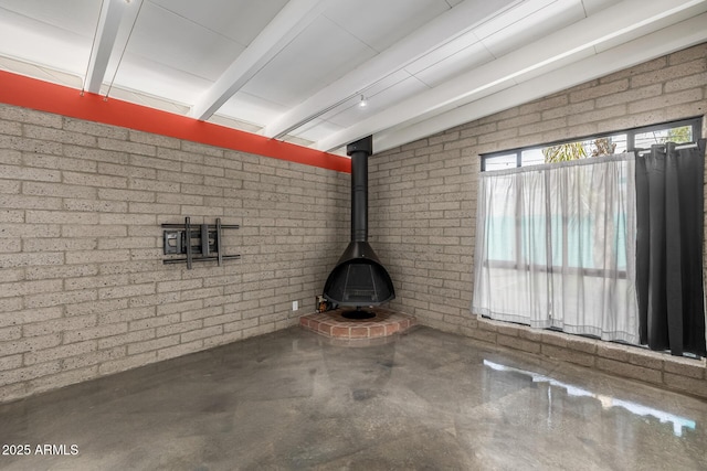 5739 N 11th St, Phoenix, AZ 85014 - unfurnished living room featuring a wood stove and concrete flooring