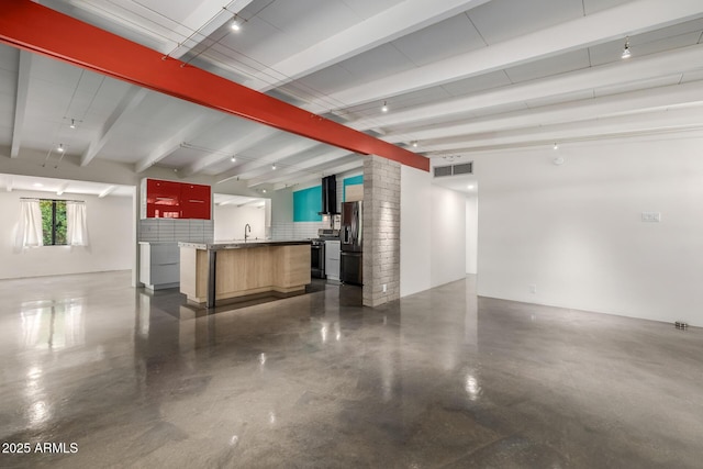 5739 N 11th St, Phoenix, AZ 85014 - unfurnished living room featuring concrete flooring, beam ceiling, a sink, and decorative columns