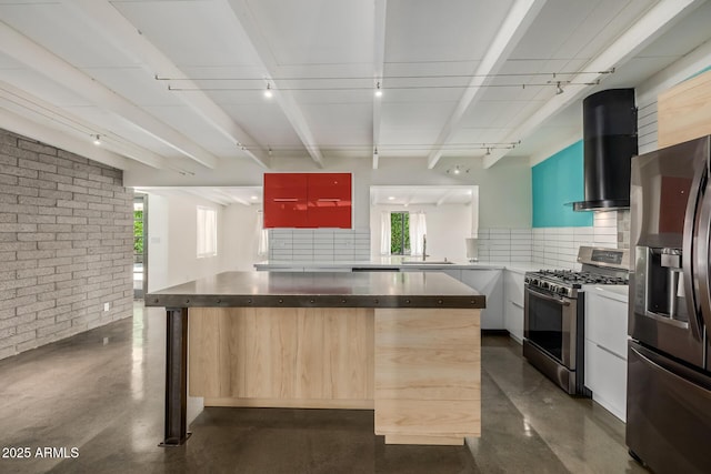 5739 N 11th St, Phoenix, AZ 85014 - kitchen featuring appliances with stainless steel finishes, brick wall, wall chimney exhaust hood, modern cabinets, and dark countertops