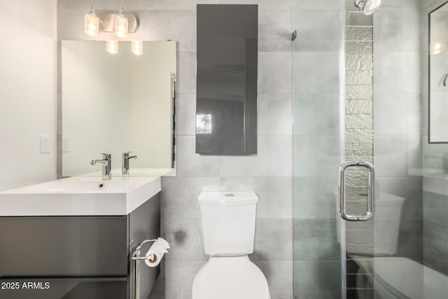5739 N 11th St, Phoenix, AZ 85014 - bathroom with toilet, vanity, a shower stall, and tile walls