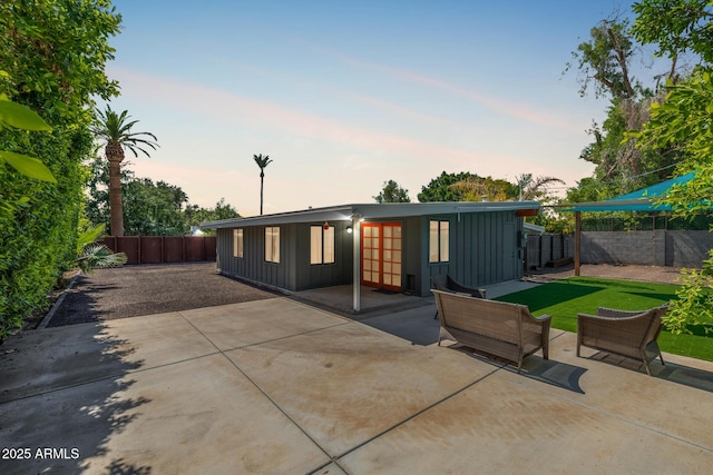 5739 N 11th St, Phoenix, AZ 85014 - back of property featuring board and batten siding, a patio area, and a fenced backyard