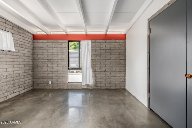 5739 N 11th St, Phoenix, AZ 85014 - unfurnished room featuring finished concrete flooring and brick wall