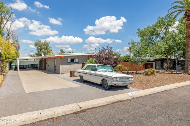 5739 N 11th St, Phoenix, AZ 85014 - view of front facade featuring driveway, brick siding, and a carport
