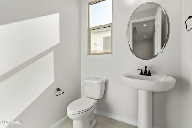 bathroom with toilet and tile patterned floors