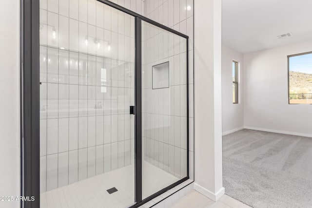 bathroom with a shower with shower door