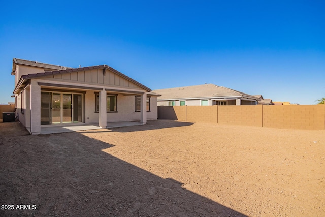 back of property with central AC and a patio area