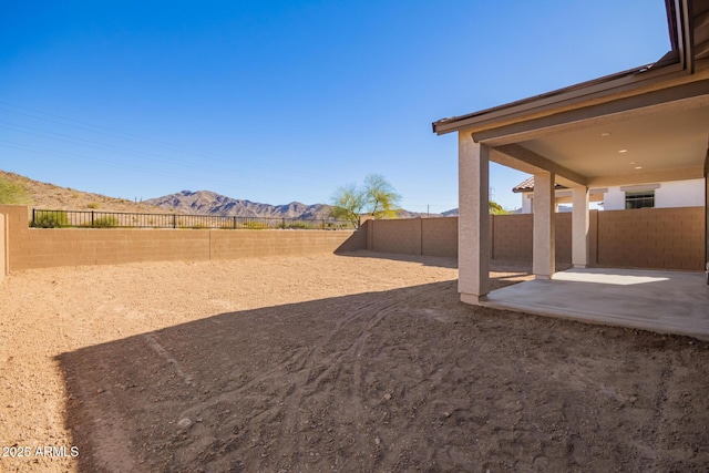 view of yard with a mountain view and a patio