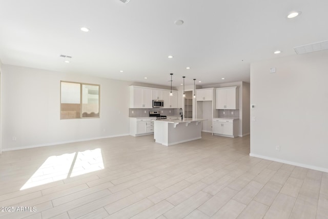 unfurnished living room featuring sink