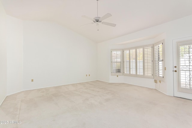 carpeted empty room featuring ceiling fan and vaulted ceiling