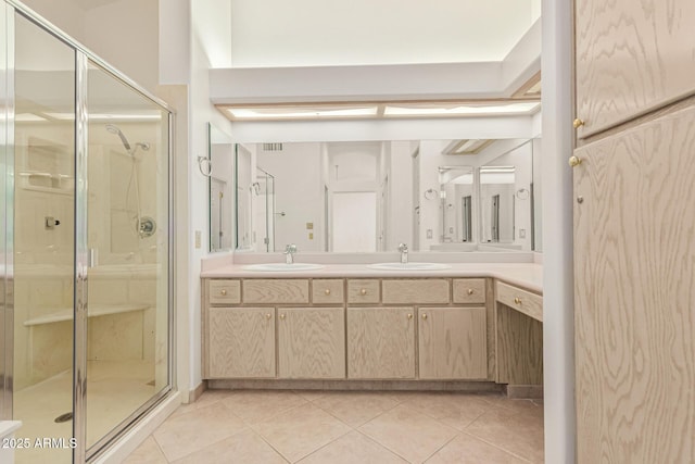 bathroom with vanity, an enclosed shower, and tile patterned flooring