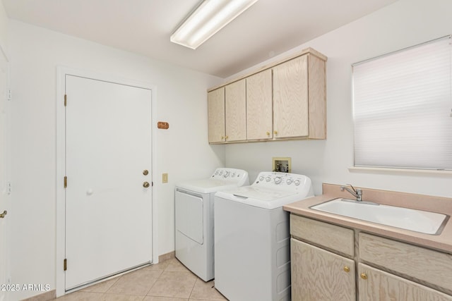 laundry room featuring cabinets, sink, light tile patterned floors, and washer and clothes dryer