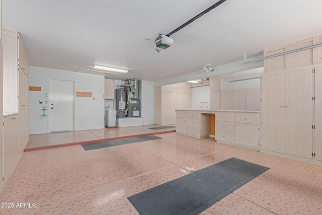 garage with a garage door opener and water heater