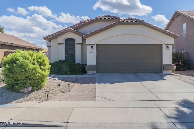 mediterranean / spanish-style home with a garage