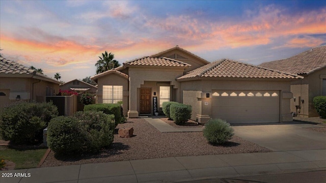 4459 E Desert Wind Dr, Phoenix, AZ 85044 - mediterranean / spanish house with an attached garage, stucco siding, a tile roof, and concrete driveway