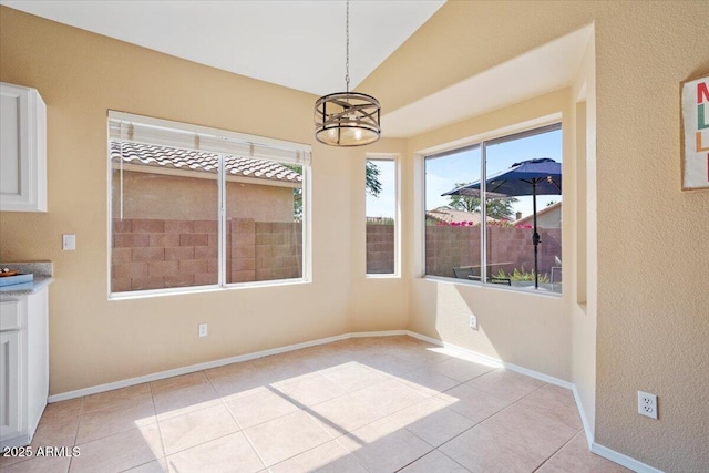 4459 E Desert Wind Dr, Phoenix, AZ 85044 - unfurnished dining area featuring a chandelier, light tile patterned floors, and vaulted ceiling