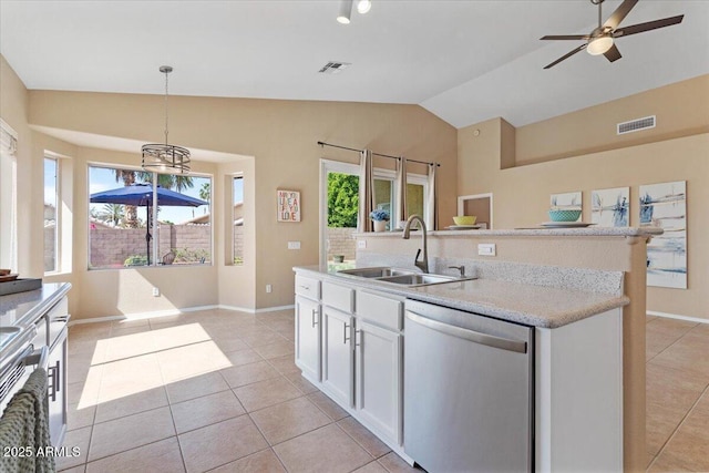 4459 E Desert Wind Dr, Phoenix, AZ 85044 - kitchen with dishwasher, vaulted ceiling, light tile patterned floors, an island with sink, and white cabinets