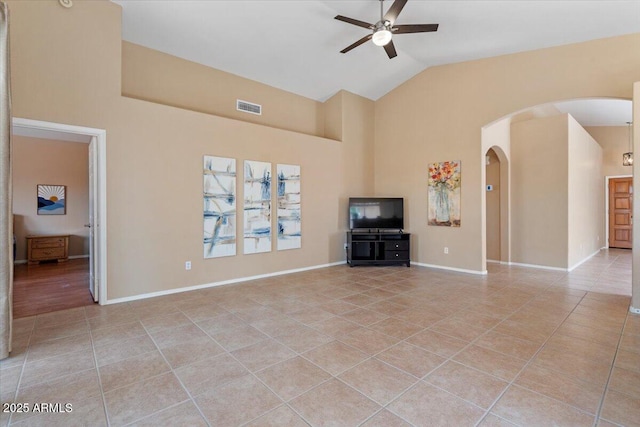 4459 E Desert Wind Dr, Phoenix, AZ 85044 - unfurnished living room with a ceiling fan, light tile patterned floors, arched walkways, and high vaulted ceiling