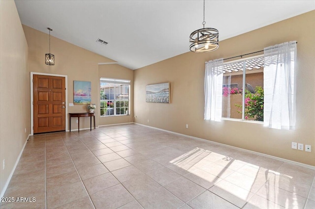 4459 E Desert Wind Dr, Phoenix, AZ 85044 - empty room with a chandelier, light tile patterned floors, and high vaulted ceiling