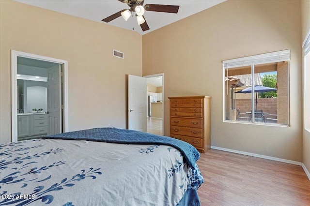 4459 E Desert Wind Dr, Phoenix, AZ 85044 - bedroom with high vaulted ceiling, wood finished floors, ensuite bath, and a ceiling fan