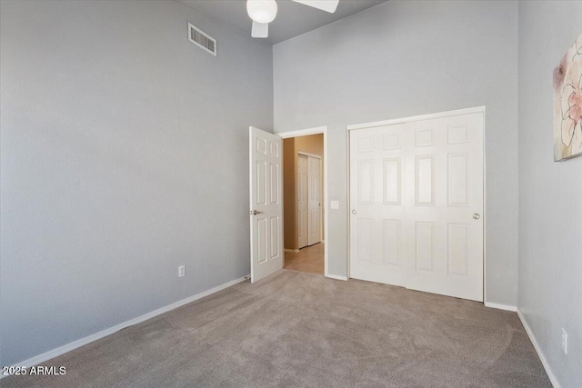 4459 E Desert Wind Dr, Phoenix, AZ 85044 - unfurnished bedroom featuring carpet, a towering ceiling, and a ceiling fan