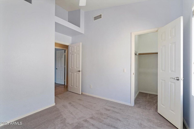 4459 E Desert Wind Dr, Phoenix, AZ 85044 - unfurnished bedroom featuring carpet, a spacious closet, and a closet