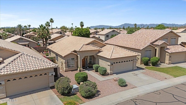 4459 E Desert Wind Dr, Phoenix, AZ 85044 - view of front of home with driveway, a tiled roof, stucco siding, a residential view, and an attached garage