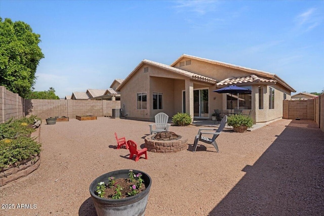 4459 E Desert Wind Dr, Phoenix, AZ 85044 - rear view of property with an outdoor fire pit, stucco siding, a patio area, a fenced backyard, and a tiled roof