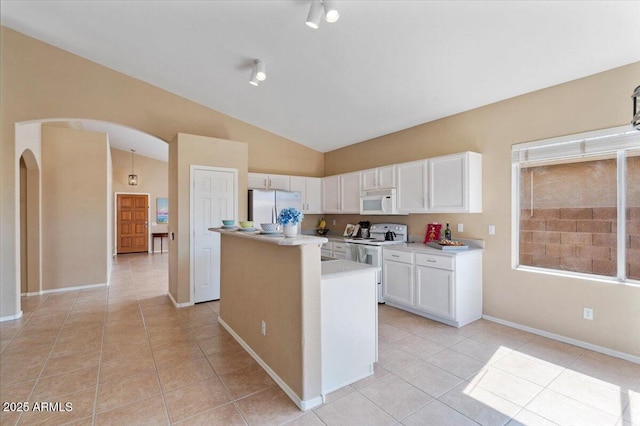 4459 E Desert Wind Dr, Phoenix, AZ 85044 - kitchen featuring white appliances, arched walkways, light tile patterned floors, a center island, and white cabinets