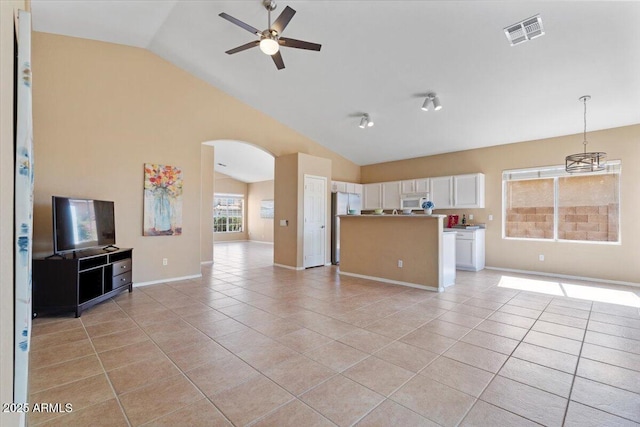 4459 E Desert Wind Dr, Phoenix, AZ 85044 - unfurnished living room with vaulted ceiling, a ceiling fan, light tile patterned flooring, and arched walkways