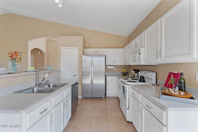 4459 E Desert Wind Dr, Phoenix, AZ 85044 - kitchen with stainless steel appliances, lofted ceiling, white cabinetry, light tile patterned flooring, and arched walkways