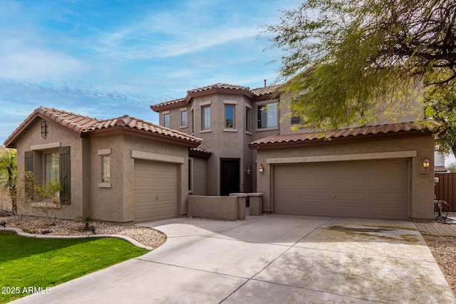 mediterranean / spanish-style house featuring a tile roof, driveway, an attached garage, and stucco siding