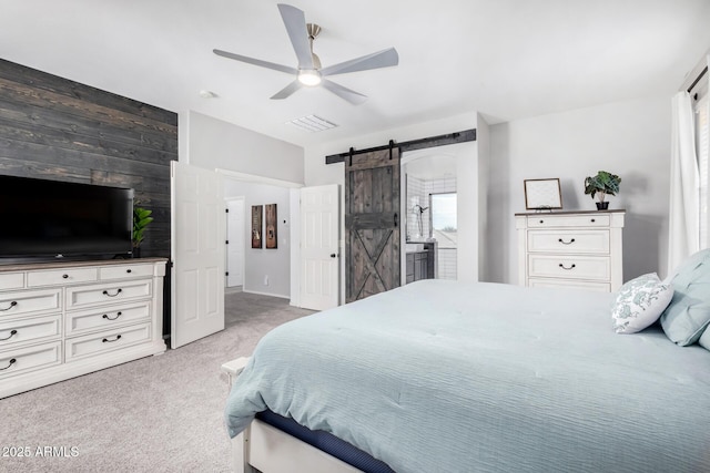 bedroom with lofted ceiling, light colored carpet, visible vents, a barn door, and ceiling fan