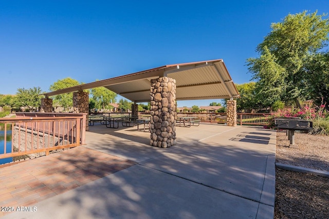 view of property's community featuring fence and a patio