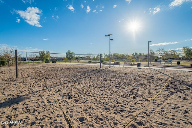 surrounding community featuring fence and volleyball court