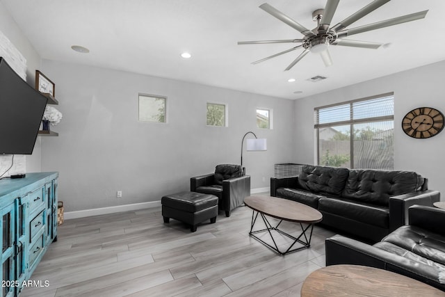 living room featuring light wood finished floors, baseboards, a ceiling fan, and recessed lighting