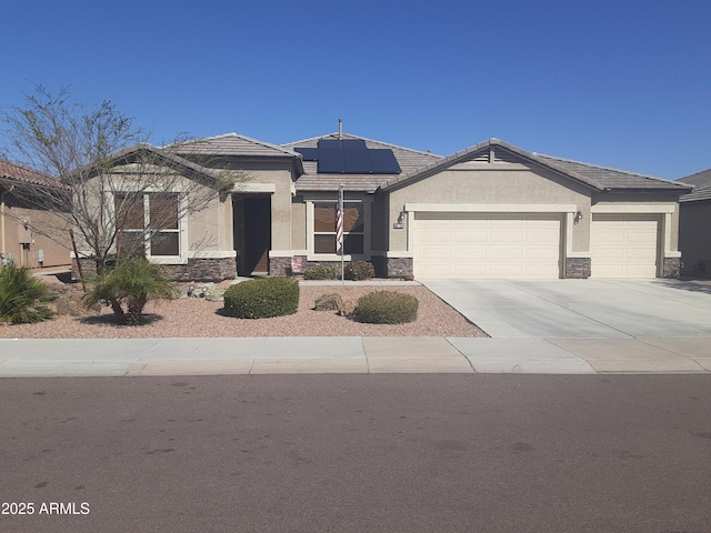 view of front of home featuring a garage, stone siding, driveway, and stucco siding