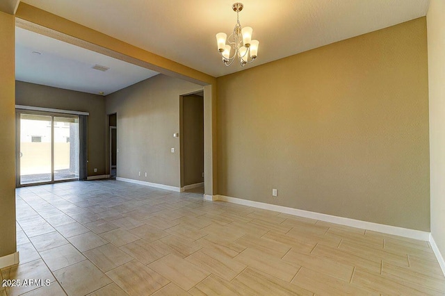 unfurnished room featuring visible vents, baseboards, and an inviting chandelier