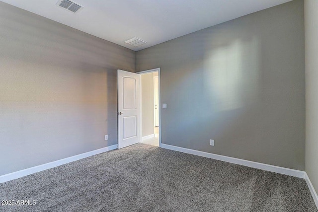 unfurnished room featuring baseboards, visible vents, and carpet flooring