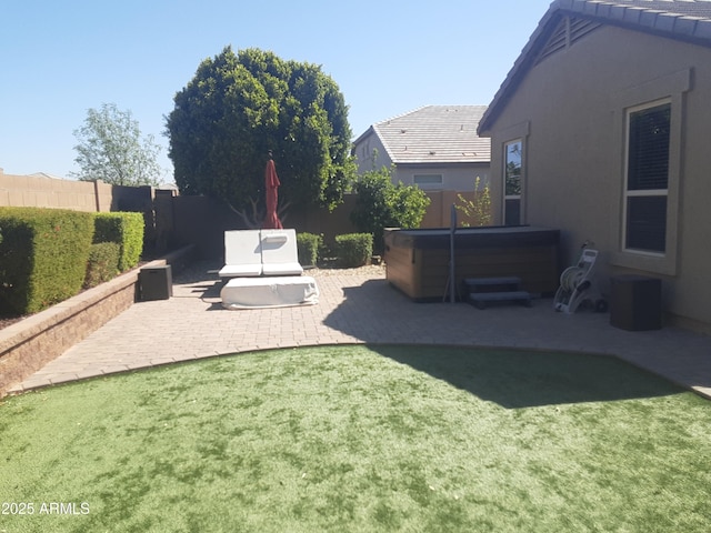 view of yard featuring a patio area, a hot tub, and a fenced backyard