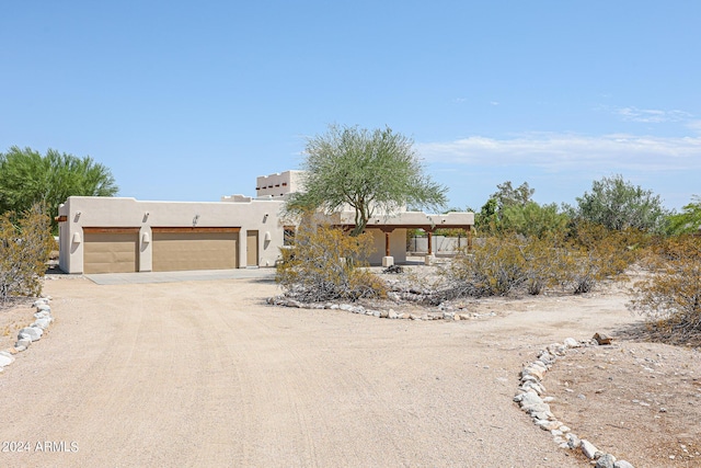 pueblo-style house with a garage