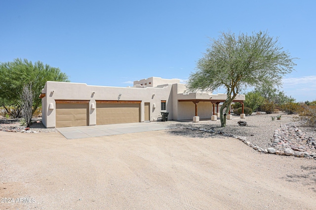 adobe home featuring a garage