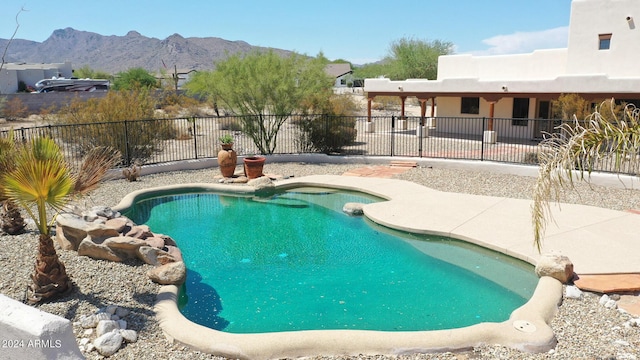 view of swimming pool with a mountain view and a patio area