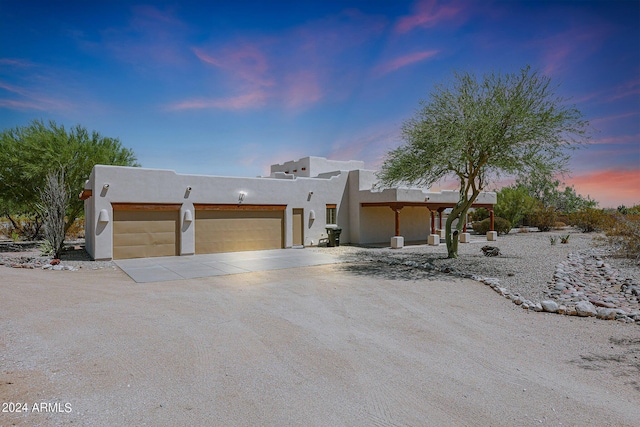 southwest-style home with a garage