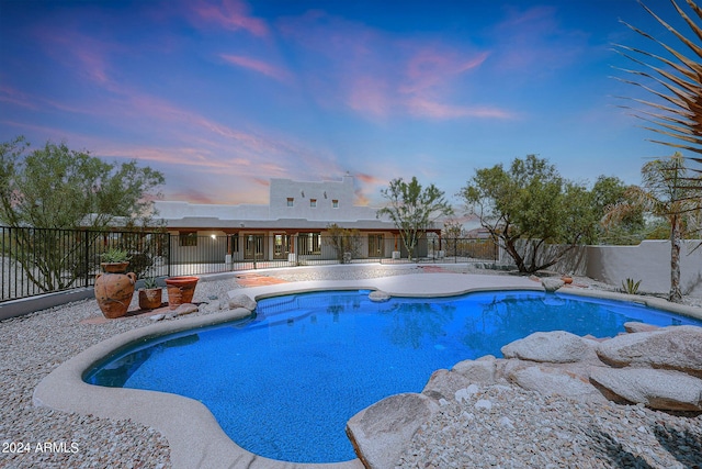 view of pool at dusk