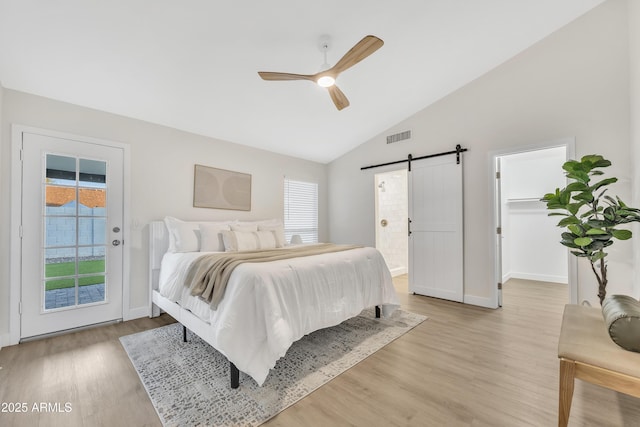7685 W San Miguel Ave, Glendale, AZ 85303 - bedroom featuring a barn door, access to exterior, light wood-style flooring, a spacious closet, and ceiling fan
