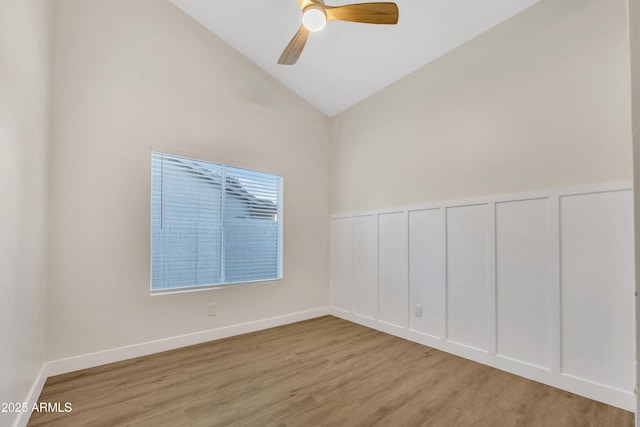 7685 W San Miguel Ave, Glendale, AZ 85303 - unfurnished room featuring wood finished floors, ceiling fan, a decorative wall, a wainscoted wall, and high vaulted ceiling