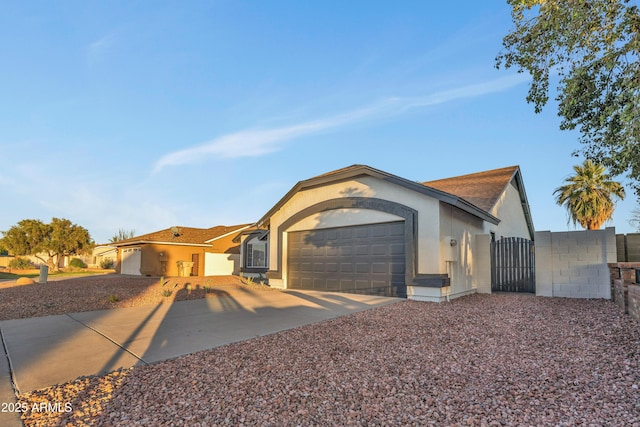 7685 W San Miguel Ave, Glendale, AZ 85303 - ranch-style house featuring stucco siding, a garage, concrete driveway, and a gate