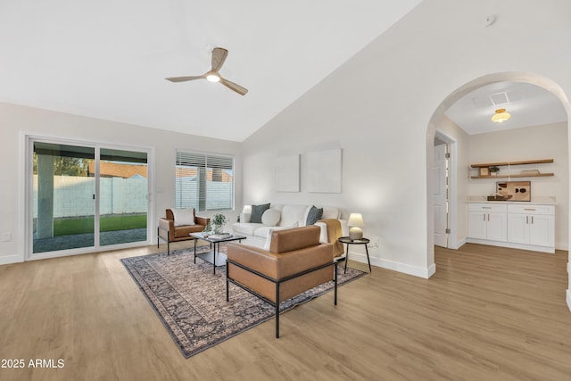7685 W San Miguel Ave, Glendale, AZ 85303 - living area featuring arched walkways, light wood finished floors, a ceiling fan, and high vaulted ceiling